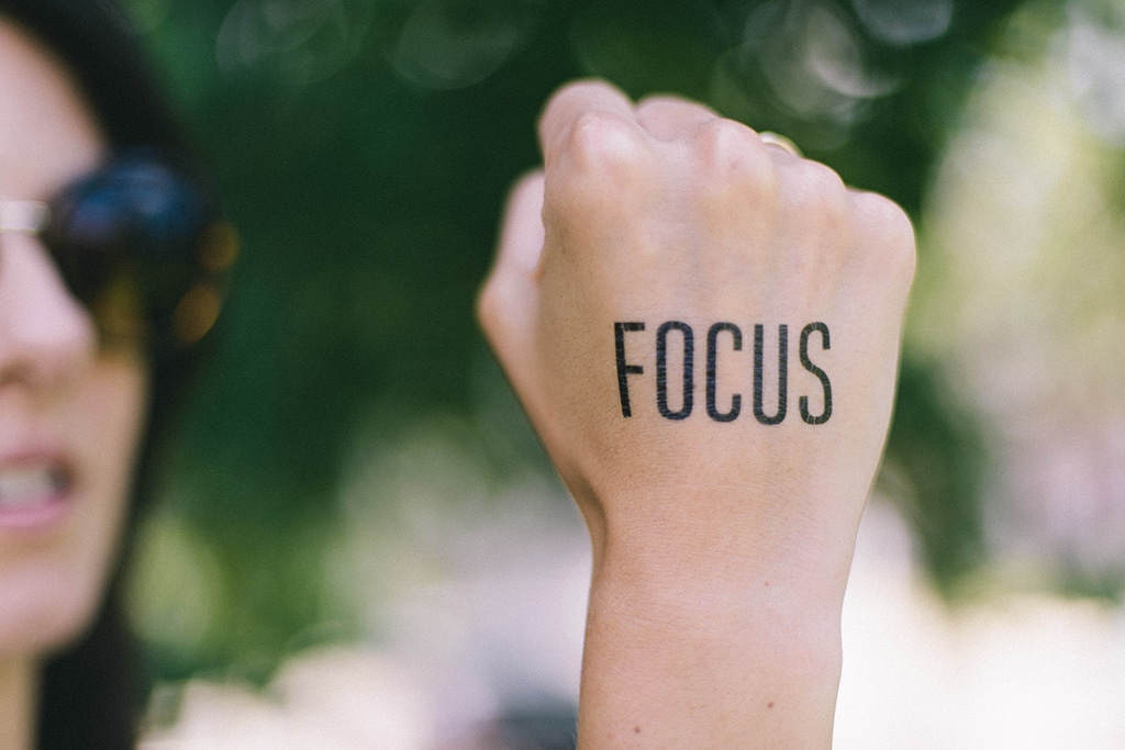 Photo of the word focus written on a hand