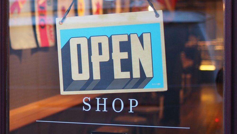 Open shop sign on door - Start your first business with no money