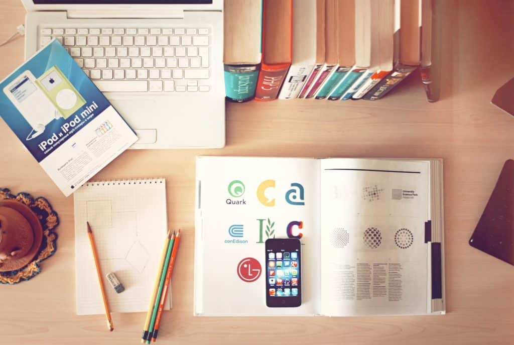 Graphic design logos, textbook, notebook & laptop - Marketing Strategies for Designers