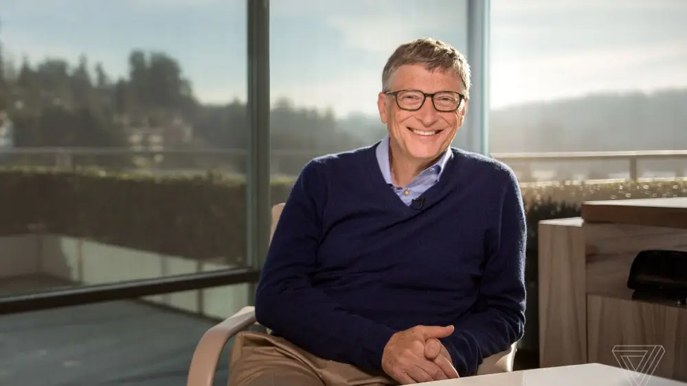 Bill Gates smiling at desk - 6 Valuable Branding Lessons from Millionaire Entrepreneurs