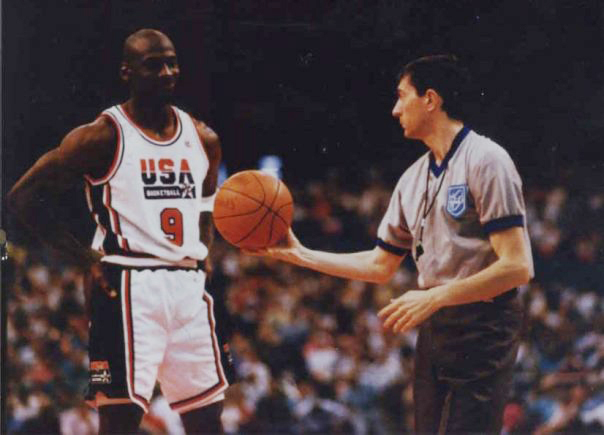 Michael Jordan on court with referee gathering competitive intelligence