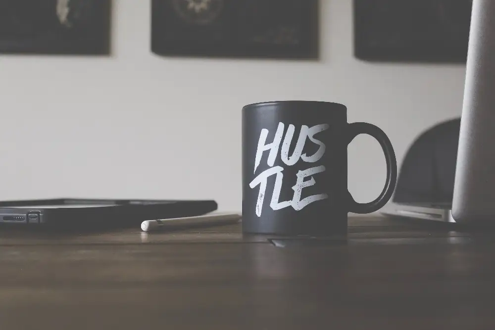 Hustle mug on freelancer's desk