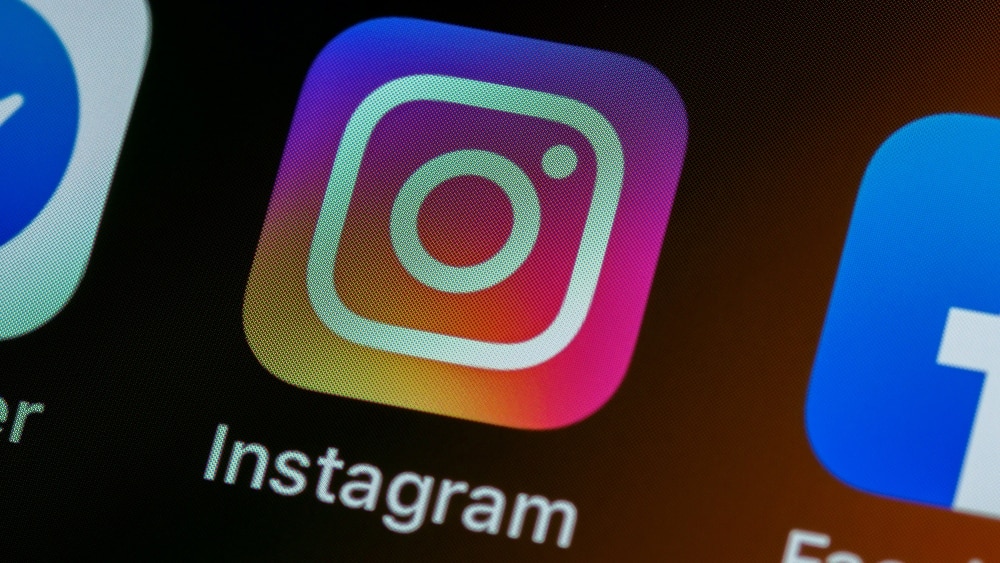 Instagram logo on phone - Reels Video Marketing