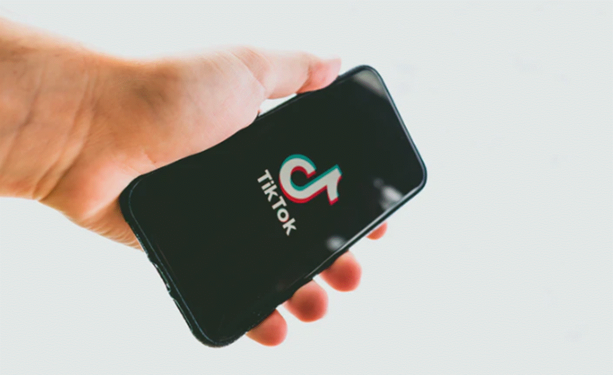 TikTok logo on phone in man's hand